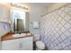 Cozy bathroom featuring a vanity, mirror, toilet, and bathtub with shower curtain for comfort and functionality at 432 W Worthington Ave, Charlotte, NC 28203