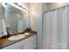 Bright bathroom with a vanity, mirror, and bathtub with shower curtain for a comfortable and functional space at 432 W Worthington Ave, Charlotte, NC 28203