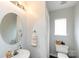 A compact half bath with a round mirror, streamlined fixtures, and neutral color scheme, for efficient functionality at 432 W Worthington Ave, Charlotte, NC 28203