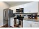 Bright kitchen features stainless steel appliances, white cabinets, and granite countertops at 432 W Worthington Ave, Charlotte, NC 28203