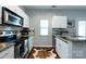 Well-lit kitchen features granite countertops, stainless steel appliances, and warm wood flooring at 432 W Worthington Ave, Charlotte, NC 28203