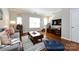Cozy living area showcasing hardwood floors, comfortable seating, and an entertainment center with stairs on the right at 432 W Worthington Ave, Charlotte, NC 28203