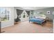 A well-lit bedroom featuring a large window, a cozy chair, and colorful bedding at 517 Morrows Turnout Way, Pineville, NC 28134