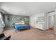 Cozy bedroom with a colorful bedspread, dresser, and decorative wall art at 517 Morrows Turnout Way, Pineville, NC 28134