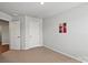 Bare bedroom with posters on the wall and neutral colored carpet at 517 Morrows Turnout Way, Pineville, NC 28134