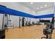Gym with a variety of exercise machines, set against a white and blue wall backdrop and wood floor at 517 Morrows Turnout Way, Pineville, NC 28134