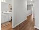 Bright hallway featuring wood floors and an adjacent bathroom at 517 Morrows Turnout Way, Pineville, NC 28134