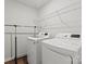 Laundry room featuring modern washer and dryer, storage rack, and a convenient clothing rack for drying clothes at 517 Morrows Turnout Way, Pineville, NC 28134