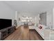 Open-concept living room featuring hardwood floors and modern décor at 517 Morrows Turnout Way, Pineville, NC 28134