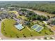 Aerial view of neighborhood amenities including a pool, clubhouse, and tennis courts near the river at 5244 Admirals Lndg, Lancaster, SC 29720