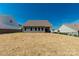 Back of house featuring a newly-strawed backyard, view of the home's exterior, and neighboring properties at 5244 Admirals Lndg, Lancaster, SC 29720