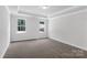Spacious bedroom with plush carpet, white walls, tray ceiling, and natural light from two windows at 5244 Admirals Lndg, Lancaster, SC 29720