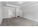 Bright bedroom featuring a tray ceiling, plush carpeting, and doors leading to the bathroom and closet at 5244 Admirals Lndg, Lancaster, SC 29720