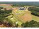 Aerial view of a beautifully landscaped golf course surrounded by green fairways and mature trees at 5244 Admirals Lndg, Lancaster, SC 29720