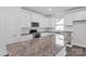 Stylish kitchen boasts granite countertops, white cabinets, stainless appliances, and backsplash at 5244 Admirals Lndg, Lancaster, SC 29720