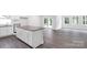 Kitchen island with a gray countertop and ample cabinet space, with view into a bright living space at 5244 Admirals Lndg, Lancaster, SC 29720