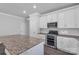 Modern kitchen featuring granite countertops, stainless steel appliances, and white cabinetry at 5244 Admirals Lndg, Lancaster, SC 29720