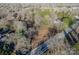 Aerial view featuring a plot of land nestled among trees and greenery in a residential neighborhood near a road at 531 Winding Way # 9, Belmont, NC 28012