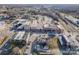 Aerial shot capturing a block of commercial buildings and parking lots in a well-established neighborhood with tree coverage at 531 Winding Way # 9, Belmont, NC 28012