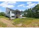 The backyard reveals a modern house design with a screened porch, set against a lush green yard at 537 Riddle Mill Rd, Clover, SC 29710