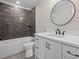 Modern bathroom with a vanity, a sink, a round mirror, and a tiled shower at 537 Riddle Mill Rd, Clover, SC 29710