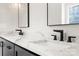 Bathroom detail of double sinks with marble countertops and black modern fixtures at 537 Riddle Mill Rd, Clover, SC 29710