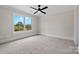 Bright, carpeted bedroom with a ceiling fan and a large window offering serene views of the outdoors at 537 Riddle Mill Rd, Clover, SC 29710