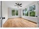 Bright bedroom featuring hardwood floors, a ceiling fan, large windows, and white trim at 537 Riddle Mill Rd, Clover, SC 29710