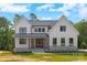 New construction two-story home with white siding, gray accents, black-trimmed windows, and covered porch at 537 Riddle Mill Rd, Clover, SC 29710