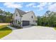 Exterior showcases a modern home, complete with a concrete driveway and an attached garage, surrounded by nature at 537 Riddle Mill Rd, Clover, SC 29710