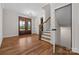 Bright foyer with hardwood floors, stairs, front door, and elegant light fixtures at 537 Riddle Mill Rd, Clover, SC 29710