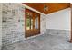 Close up of double wood front doors, stone floor, stone walls, and wood plank ceiling at 537 Riddle Mill Rd, Clover, SC 29710