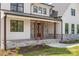 Inviting front porch with stone columns, wood accents, stone floor, and double front door at 537 Riddle Mill Rd, Clover, SC 29710