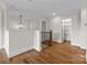 Spacious hallway with hardwood floors, white trim, and views of the staircase and storage room at 537 Riddle Mill Rd, Clover, SC 29710