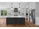 Modern kitchen featuring a large island with seating, stainless steel appliances, and hardwood floors at 537 Riddle Mill Rd, Clover, SC 29710
