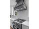 Modern kitchen range with decorative tile backsplash and stainless steel hood at 537 Riddle Mill Rd, Clover, SC 29710