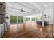 Open-concept living room with hardwood floors, stone fireplace, and kitchen in view at 537 Riddle Mill Rd, Clover, SC 29710