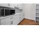 Bright mudroom features white cabinets, marble countertops, and stainless steel microwave at 537 Riddle Mill Rd, Clover, SC 29710