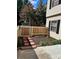 Back yard features wood fence, stepping stones, mulch, and landscaping at 5941 Quail Hollow Rd # F, Charlotte, NC 28210