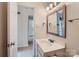 Bathroom features a white vanity with a new mirror and modern sink fixtures at 5941 Quail Hollow Rd # F, Charlotte, NC 28210