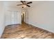 Bedroom features light wood floors, neutral walls, and closet access to the bathroom at 5941 Quail Hollow Rd # F, Charlotte, NC 28210