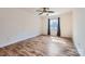 Bedroom boasting hardwood floors, neutral paint, a fan, and a window providing natural light at 5941 Quail Hollow Rd # F, Charlotte, NC 28210