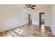 Spacious bedroom with wood-look flooring, modern fan, and bright, neutral paint at 5941 Quail Hollow Rd # F, Charlotte, NC 28210