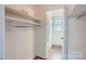 Large closet with shelves and rod, as well as access to the bathroom at 5941 Quail Hollow Rd # F, Charlotte, NC 28210