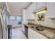 Bright kitchen with granite counters, stainless steel appliances, and white cabinets offering ample storage at 5941 Quail Hollow Rd # F, Charlotte, NC 28210