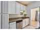 Kitchen featuring granite counters, stainless steel appliances, and bright white cabinets at 5941 Quail Hollow Rd # F, Charlotte, NC 28210