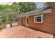 Brick house exterior features a stained wood deck at 6117 Yellowood Rd, Charlotte, NC 28210