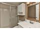 Bathroom features a shower with glass doors, wallpaper, and a large mirror at 6117 Yellowood Rd, Charlotte, NC 28210