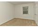 Neutral bedroom featuring a window with blinds, an overhead light and a closet at 6117 Yellowood Rd, Charlotte, NC 28210