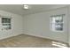 Neutral bedroom featuring carpet, two windows, and an overhead light at 6117 Yellowood Rd, Charlotte, NC 28210